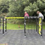 Children playing on a modern outdoor climbing frame in a park