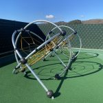 Steel climbing frame on green safety surfacing