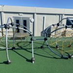 Steel climbing frame on green safety surfacing