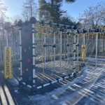 Outdoor gym equipment installed beside climbing frame