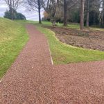 Long Tigermulch pathway winding through trees